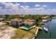 An aerial view of a waterfront house with a pool and private dock and boat in a canal community at 2063 Illinois Ne Ave, St Petersburg, FL 33703