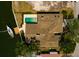 Aerial view of waterfront home featuring a private dock, pool, and stylish architecture at 2063 Illinois Ne Ave, St Petersburg, FL 33703