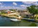 A backyard view of a waterfront house with a private dock, boat, and a sparkling pool with a lounge area at 2063 Illinois Ne Ave, St Petersburg, FL 33703