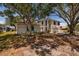 Two-story home with a tile roof, arched windows, mature landscaping, and a sprawling lawn at 2063 Illinois Ne Ave, St Petersburg, FL 33703