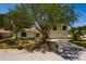 Home with mature shade tree on the front lawn and a driveway leading to the garage at 2063 Illinois Ne Ave, St Petersburg, FL 33703