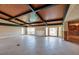 Expansive living room with exposed beam ceiling and large windows, a remodel opportunity at 2063 Illinois Ne Ave, St Petersburg, FL 33703