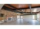 Spacious living room with stone fireplace, ceiling fan and natural light, ready for renovation at 2063 Illinois Ne Ave, St Petersburg, FL 33703
