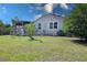 A spacious backyard features a patio deck and a swing bench in lush green grass, and an American Flag at 2132 40Th N Ave, St Petersburg, FL 33714