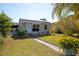 Inviting home exterior with well-maintained lawn and walkway, enhanced by solar panels on the roof at 2132 40Th N Ave, St Petersburg, FL 33714