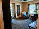 Inviting living room featuring comfortable armchairs, plush carpeting, and a view to the outside at 2132 40Th N Ave, St Petersburg, FL 33714