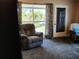 Inviting living room featuring comfortable armchairs, plush carpeting, and a view to the outside at 2132 40Th N Ave, St Petersburg, FL 33714