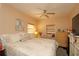 Comfortable main bedroom features a ceiling fan, neutral paint, a window and a chest of drawers at 2132 40Th N Ave, St Petersburg, FL 33714