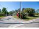A street view showcases a tree with vibrant red flowers growing in the yard at 2132 40Th N Ave, St Petersburg, FL 33714