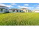 Beautiful backyard with lush green grass and modern homes at 22196 Calisto Way, Land O Lakes, FL 34637