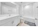 Bright bathroom with a tub and shower, tiled with white subway tiles, and a single sink vanity at 22196 Calisto Way, Land O Lakes, FL 34637