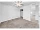 Inviting bedroom featuring neutral carpet, a ceiling fan, and an adjacent closet at 22196 Calisto Way, Land O Lakes, FL 34637