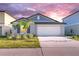 Charming single-story home featuring a well-manicured lawn and a two-car garage at 22196 Calisto Way, Land O Lakes, FL 34637