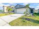 Charming single-Gathering home with a white garage door, well-manicured lawn, and beautiful landscaping features at 22196 Calisto Way, Land O Lakes, FL 34637