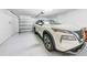 Clean, spacious garage featuring a new SUV and an automatic door opener at 22196 Calisto Way, Land O Lakes, FL 34637