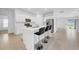 Modern kitchen with an island with stools, stainless appliances and plenty of cabinet space at 22196 Calisto Way, Land O Lakes, FL 34637