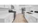A bright, modern kitchen featuring stainless steel appliances, and white cabinets at 22196 Calisto Way, Land O Lakes, FL 34637