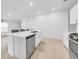 Modern kitchen featuring an island with a stainless steel sink and appliances at 22196 Calisto Way, Land O Lakes, FL 34637
