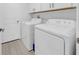 Convenient laundry room with a white washer and dryer set and upper cabinets at 22196 Calisto Way, Land O Lakes, FL 34637