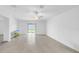 A bright living room with a sliding glass door and neutral tile flooring at 22196 Calisto Way, Land O Lakes, FL 34637