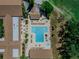 Aerial view of the large community pool, hot tub, seating, and lush landscaping at 2241 Shelly Dr # D, Palm Harbor, FL 34684