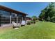 Backyard featuring well-manicured lawn, lush landscaping, and an enclosed porch at 2241 Shelly Dr # D, Palm Harbor, FL 34684