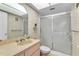 Bathroom with floral wallpaper, a glass-enclosed shower, and a vanity sink at 2241 Shelly Dr # D, Palm Harbor, FL 34684