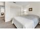 Bedroom with carpet, a double closet, a wall painting, and a corner lamp at 2241 Shelly Dr # D, Palm Harbor, FL 34684