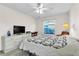 Comfortable bedroom featuring a ceiling fan, large window, and a TV on a dresser at 2241 Shelly Dr # D, Palm Harbor, FL 34684