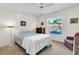Bedroom featuring a ceiling fan, large window, and a painting at 2241 Shelly Dr # D, Palm Harbor, FL 34684