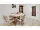 Dining area features a round table set for four, along with a china cabinet at 2241 Shelly Dr # D, Palm Harbor, FL 34684