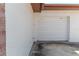 Garage featuring a white door, stucco siding, and painted brick accents at 2241 Shelly Dr # D, Palm Harbor, FL 34684
