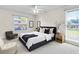 Serene bedroom featuring a comfortable bed, soft lighting, and large windows for a relaxing retreat at 2241 Shelly Dr # D, Palm Harbor, FL 34684