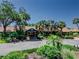 Main entrance features lush landscaping and mature trees at 2241 Shelly Dr # D, Palm Harbor, FL 34684