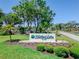 Community entrance sign to Highland Lakes Club, surrounded by mature trees and manicured landscaping at 2241 Shelly Dr # D, Palm Harbor, FL 34684