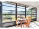 Sunroom featuring large windows, a cozy dining area, and views of the community at 2241 Shelly Dr # D, Palm Harbor, FL 34684