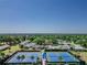 Aerial view of community tennis courts with lush green landscaping and blue courts at 2241 Shelly Dr # D, Palm Harbor, FL 34684