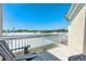 Second-story balcony with views of the surrounding neighborhood from wood chairs behind a white fence at 232 Columbia Dr, Tampa, FL 33606