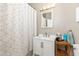 Clean bathroom with a modern vanity, shower with geometric curtain, and neutral wall color at 232 Columbia Dr, Tampa, FL 33606
