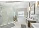 Spa-like bathroom featuring a glass-enclosed shower, soaking tub, and modern fixtures at 232 Columbia Dr, Tampa, FL 33606