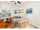 Cozy bedroom with wood floors, a window with natural light, and a desk and dresser set at 232 Columbia Dr, Tampa, FL 33606