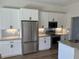 Modern kitchen with white cabinets, stainless steel appliances, subway tile backsplash, and granite countertops at 232 Columbia Dr, Tampa, FL 33606
