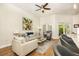 Comfortable living room featuring hardwood floors, a ceiling fan, and sliding glass doors to the patio at 232 Columbia Dr, Tampa, FL 33606
