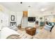 Bright living room with wood floors, white brick accent wall, and staircase leading to the upper level at 232 Columbia Dr, Tampa, FL 33606
