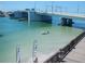 Picturesque view of the bridge on a beautiful day with turquoise water and recreational boaters at 248 137Th Cir, Madeira Beach, FL 33708
