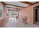 Inviting sun room with beamed ceiling, tile floors, french doors and serene water views at 248 137Th Cir, Madeira Beach, FL 33708