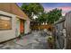 Cozy back patio, perfect for outdoor dining, with a fenced yard and mature trees providing shade at 251 72Nd Ave, St Pete Beach, FL 33706