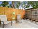 Enclosed concrete patio area with seating, fenced-in yard, and grill, perfect for relaxing at 251 72Nd Ave, St Pete Beach, FL 33706