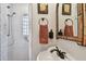 Charming bathroom features an arched doorway, tiled shower, vessel sink and unique mirror at 251 72Nd Ave, St Pete Beach, FL 33706