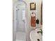 Updated bathroom featuring arched doorway, shower, and a unique vessel sink and mirror at 251 72Nd Ave, St Pete Beach, FL 33706